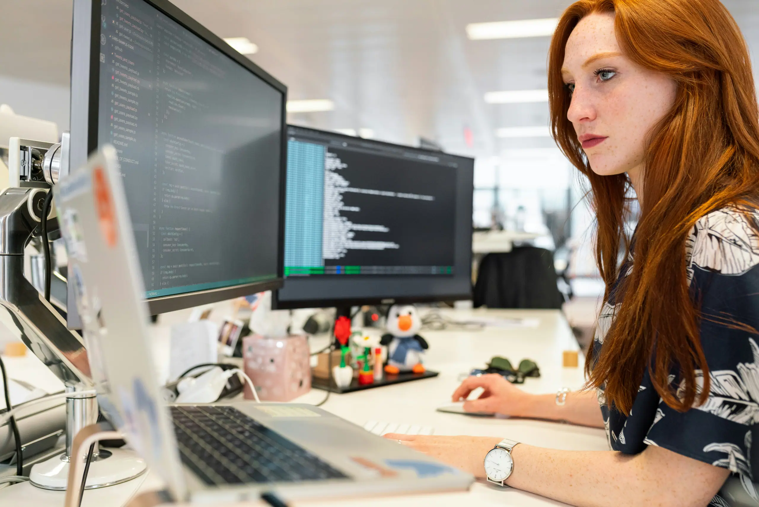 Engineer building an AI workflow at a multi-monitor desk